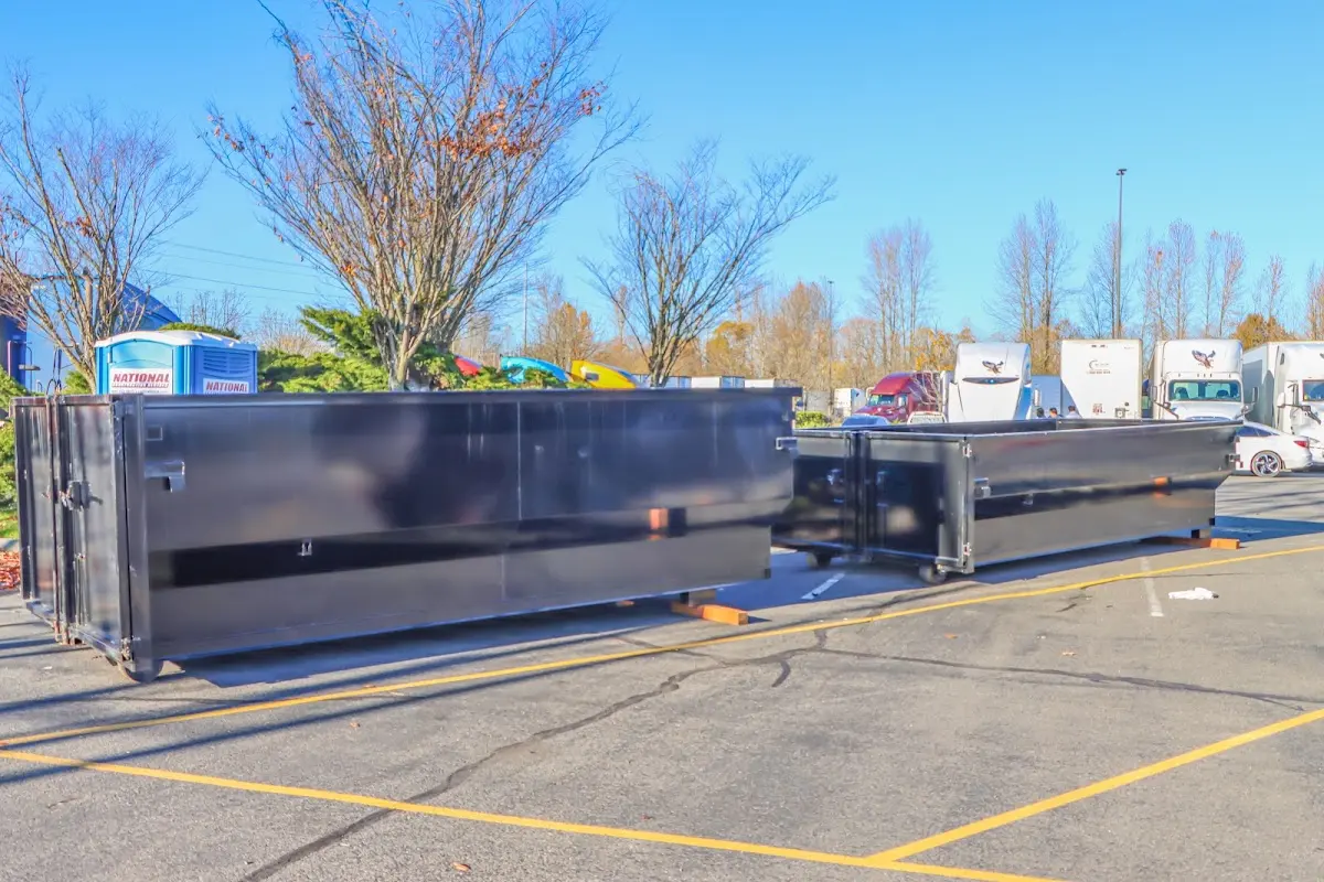 Professional dumpster rental service with roll-off container on residential driveway in Santa Maria